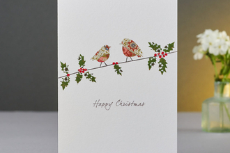 A Christmas card with two robins on
