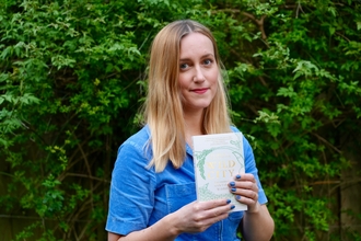 Florence Wilkinson holding her book.