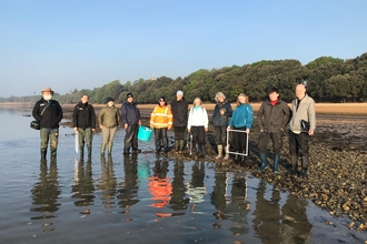 Group of volunteers taking part in seagrass survey at Calshot.