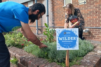 Two people gardening in urban area