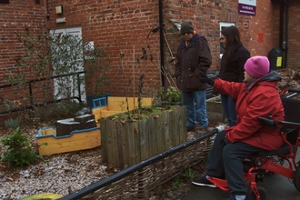 A small area containing planters outside a building. 