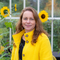 Woman in yellow jacket and sunflowers