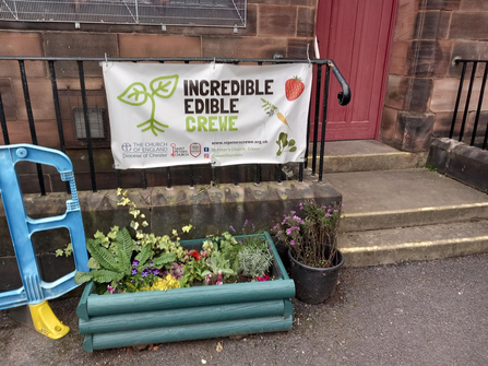 A sign outside a building reading 'Incredible Edible Crewe'