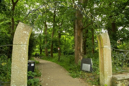 The entrance to a Spinney with woodland and a footpath