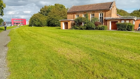 A church with mown grass in the foreground