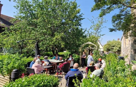 Community sitting socialising in the centre's garden. 