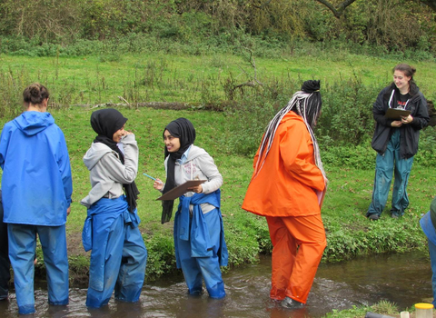 young people in a river on a residential trip