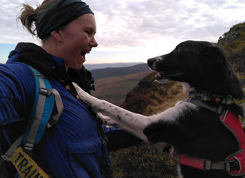 Sarah-Kay from The Wildlife Trust of South and West Wales smiles at Lily, her rescue collie, who has her front paws on Sarah-Kay's chest